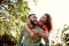 A young couple enjoying a walk in the park iStock-1300273437