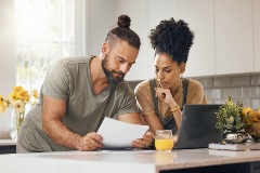 Young couple planning finances in a kitchen