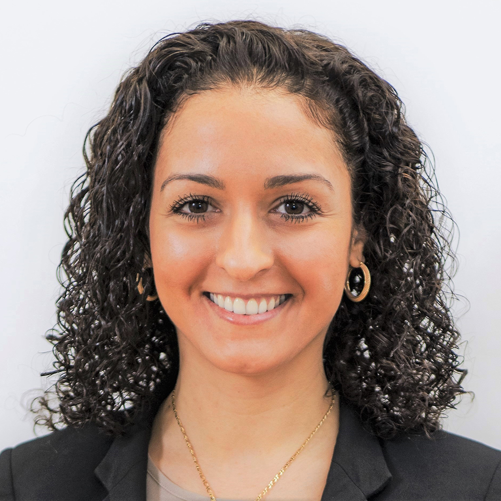Steph Douglas headshot. She has dark hair and is wearing a dark blazer