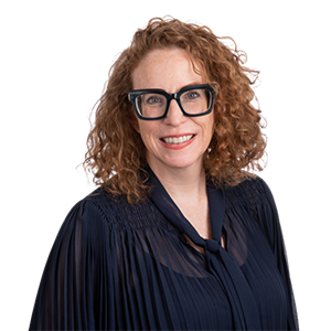 Wendy Brookhouse headshot. She is wearing a dark shirt and has dark glasses. She is smiling at the camera